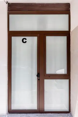 a door with two glass windows in a building at C - Design apartment El Grao close to the beach in Valencia