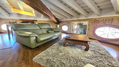 a living room with a couch and a table at Ático Exclusivo del Siglo XVI con Terraza Privada en el Corazón de Ciutat Vella in Valencia