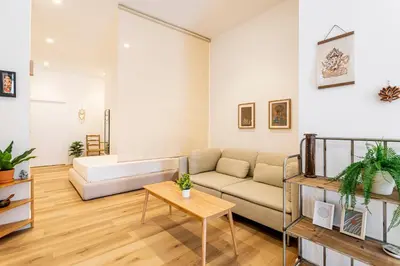 a living room with a couch and a table at Hridaya El Grao close to the sea in Valencia