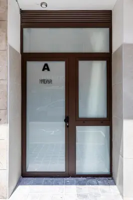 a large glass door in a building at Hridaya El Grao close to the sea in Valencia