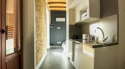 a small kitchen with a sink and a counter at Soho Valencia in Valencia
