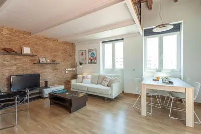 a living room with a couch and a table at Penthouse apartment historical center in Valencia