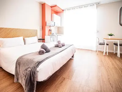 a bedroom with two beds and a table at Estudio En El Centro-Ruzafa 10D in Valencia