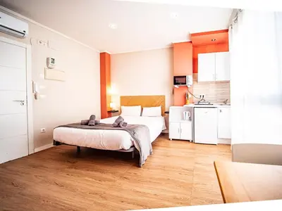 a hotel room with a bed and a kitchen at Estudio En El Centro-Ruzafa 10D in Valencia