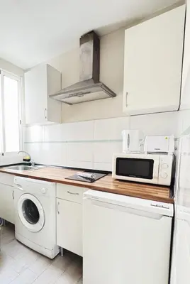 a white kitchen with a washer and dryer at Tu Apartamento En El Centro - Ruzafa 8D in Valencia