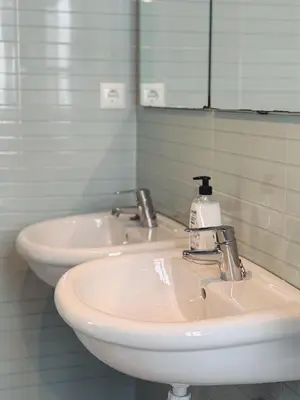 a bathroom with a white sink and a mirror at Tu Apartamento En El Centro - Ruzafa 8D in Valencia