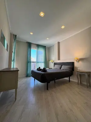 a large bedroom with a bed and a desk at Tu Apartamento En El Centro - Ruzafa 8D in Valencia