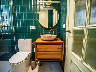 a bathroom with a sink and a toilet and a mirror at Tu Penthouse En El Centro - Ruzafa 11C in Valencia