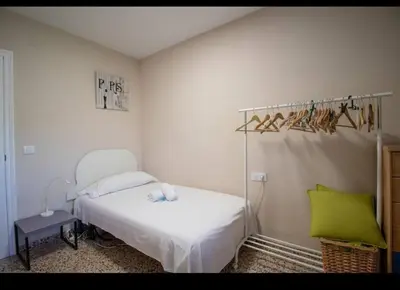 a bedroom with a white bed and a green pillow at Casa vistas al rio in Navajas
