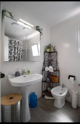 a bathroom with a white sink and a toilet at Casa vistas al rio in Navajas