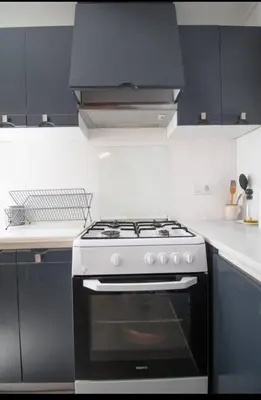a kitchen with a black and white stove top oven at Casa vistas al rio in Navajas