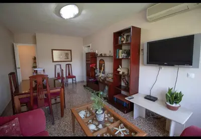 a living room with a flat screen tv on a wall at Casa vistas al rio in Navajas