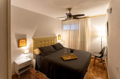 a bedroom with a bed with a table on it at A pié de playa Rincón acogedor Amanecer in Cullera