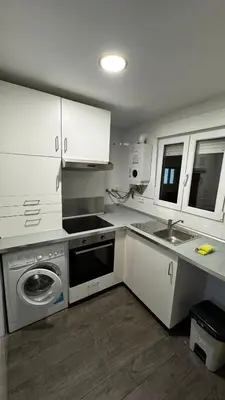 a kitchen with white cabinets and a sink and a dishwasher at Plaza la REINA 3th floor & no elevator in Valencia