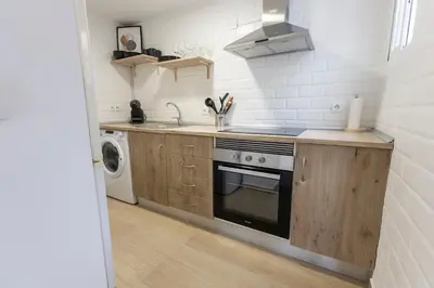 a small kitchen with a stove and a sink at Encantador Apartamento de Lujo en Valencia 3 Dormitorios in Paterna