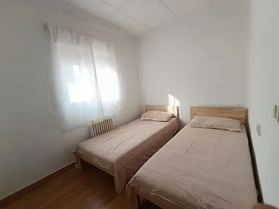 two beds in a small room with a window at El otro cielo Playamonte in Navarrés