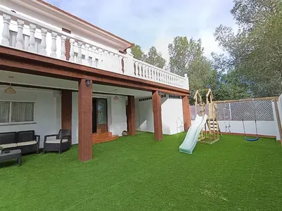 a backyard with a slide and a playground at El otro cielo Playamonte in Navarrés