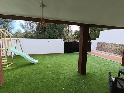 a play area with a slide and a playground at El otro cielo Playamonte in Navarrés