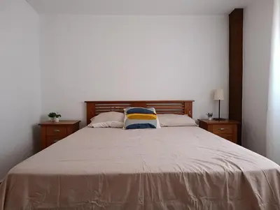 a bedroom with a large bed with two night stands at El otro cielo Playamonte in Navarrés