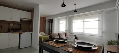 a kitchen and living room with a table with plates on it at Apartamento En La Ciudad De Las Artes y Las Ciencias in Valencia