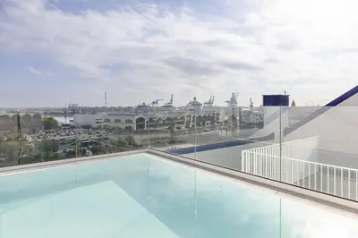 a balcony with a view of a city at ApartUP Port Marina Azura in Valencia
