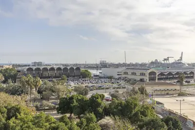 a parking lot with a cruise ship in the background at ApartUP Port Marina Azura in Valencia