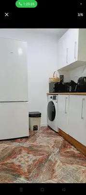 a kitchen with white cabinets and a stove top oven at Piso in Valencia