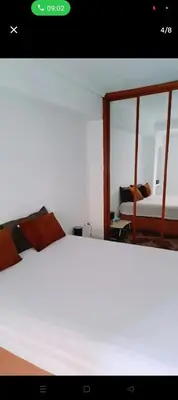 a bedroom with a white bed and a mirror at Piso in Valencia