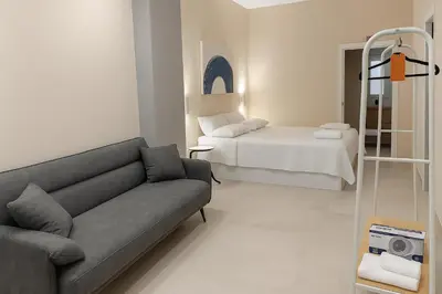 a living room with a couch and a bed at Roca Collection MSuites in Valencia