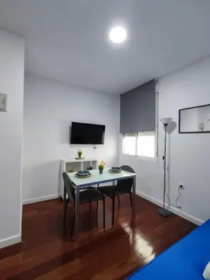 a dining room with a table and a tv at Benimaclet JTM in Valencia