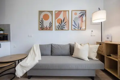 a living room with a couch and a table at Estudio con Altillo en Malilla cerca de La Fe in Valencia
