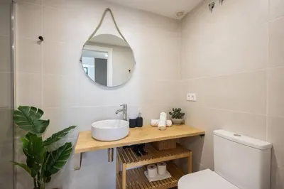 a bathroom with a sink and a mirror at Estudio con Altillo en Malilla cerca de La Fe in Valencia