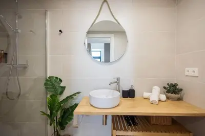 a bathroom with a sink and a mirror at Estudio con Altillo en Malilla cerca de La Fe in Valencia