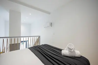 a bedroom with a bed with two towels on it at Estudio con Altillo en Malilla cerca de La Fe in Valencia