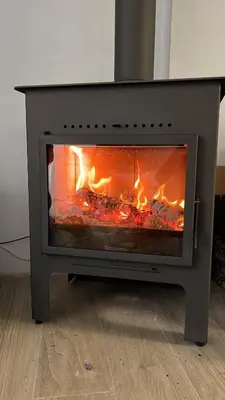 a stove with a fire inside of it at Restored house near Valencia in Simat de Valldigna