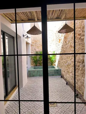 a view of a courtyard through a glass door at Casa Abadía Alojamiento completo boutique cerca de Valencia in Alfarp