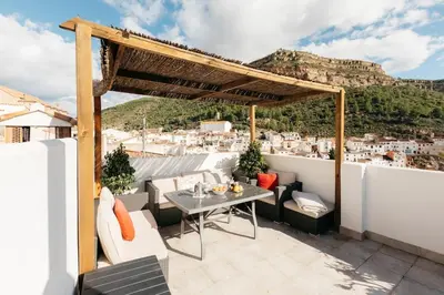 a terrace with a table and chairs on a roof at Brisas Chulilla Loft with Terrace in Chulilla