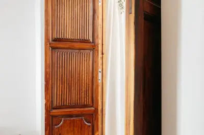 an open wooden door next to a white curtain at Brisas Chulilla Loft with Terrace in Chulilla