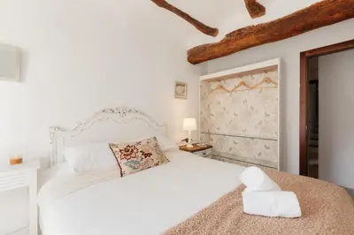 a white bedroom with a white bed and a window at Brisas Chulilla Boutique Apartment in Chulilla