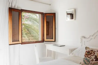 a bedroom with a bed and a window and a desk at Brisas Chulilla Boutique Apartment in Chulilla