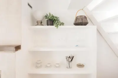 a bathroom with white shelves and a sink at Brisas Chulilla Mirador House in Chulilla
