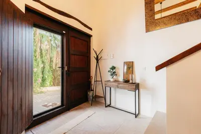 a hallway with a wooden door and a window at Brisas Chulilla Mirador House in Chulilla