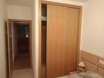 a closet in a bedroom with a bed and a door at Old red in Valencia