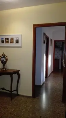a dining room with a table and chairs and a tv at Apartamento Rural La Plaza Vieja in Viver