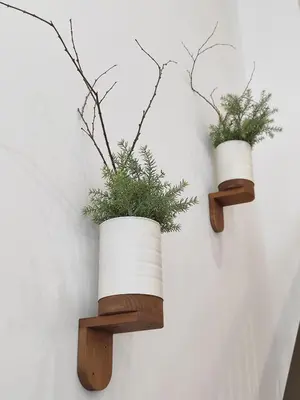 two plants in white pots on a wall at Loft acogedor junto al Roig Arena in Valencia