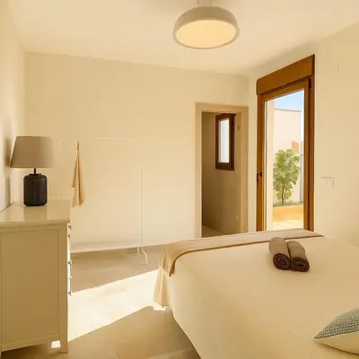 a bedroom with a bed with two shoes on it at Charming brand-new loft with garden and pool in Pla del Pou