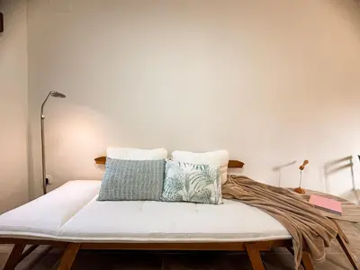 a bed with two pillows on it in a room at Charming brand-new loft with garden and pool in Pla del Pou