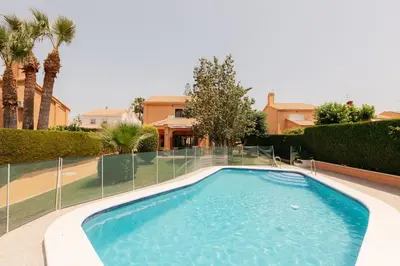 a swimming pool in front of a house at Charming brand-new loft with garden and pool in Pla del Pou