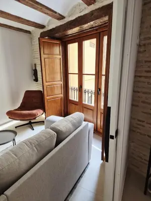 a living room with a couch and a window at Valencia Catedral Apt in Valencia