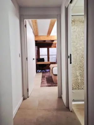 a hallway leading to a bedroom with a door open at Valencia Catedral Apt in Valencia